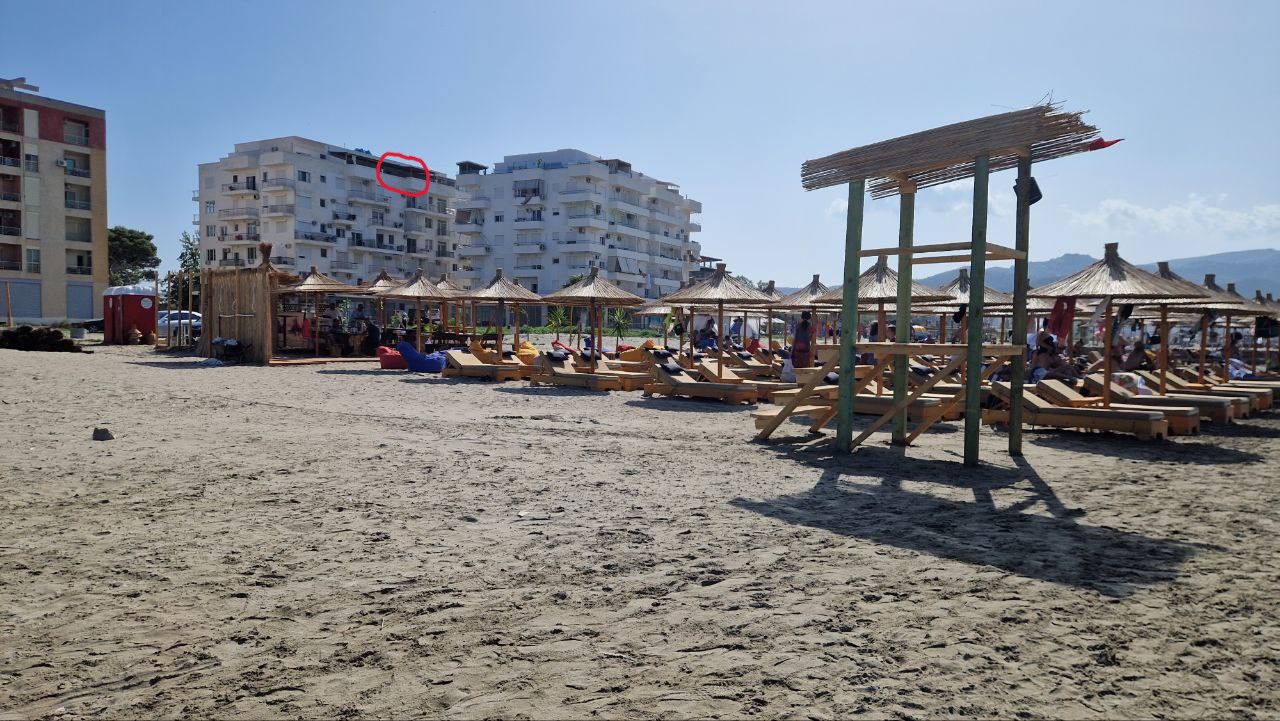 View of Vlorë penthouse apartment building from Plazhi i Ri beach showing beachfront location